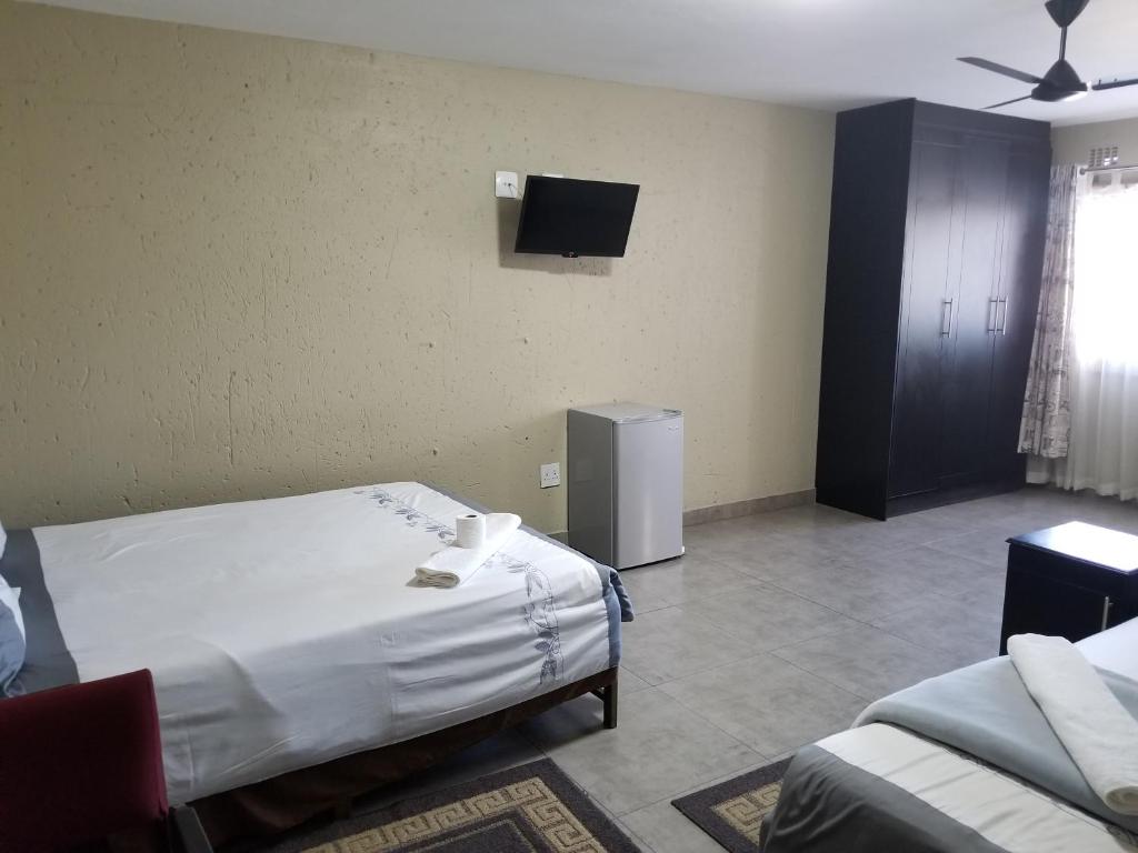 Postel nebo postele na pokoji v ubytování Chisam Guest Lodge Pty Ltd