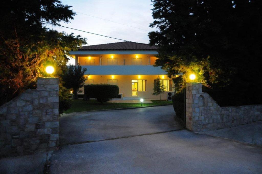 a house with lights on the side of a driveway at Hotel Pantheon in Markopoulo