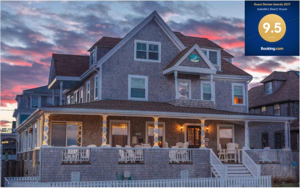 a house with a sunset in the background at Inkwell Beach Cottage in Oak Bluffs