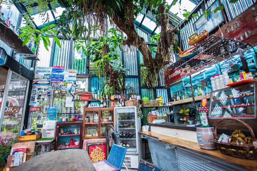 a shop with a tree in the middle of it at Artist's Place Trat in Trat