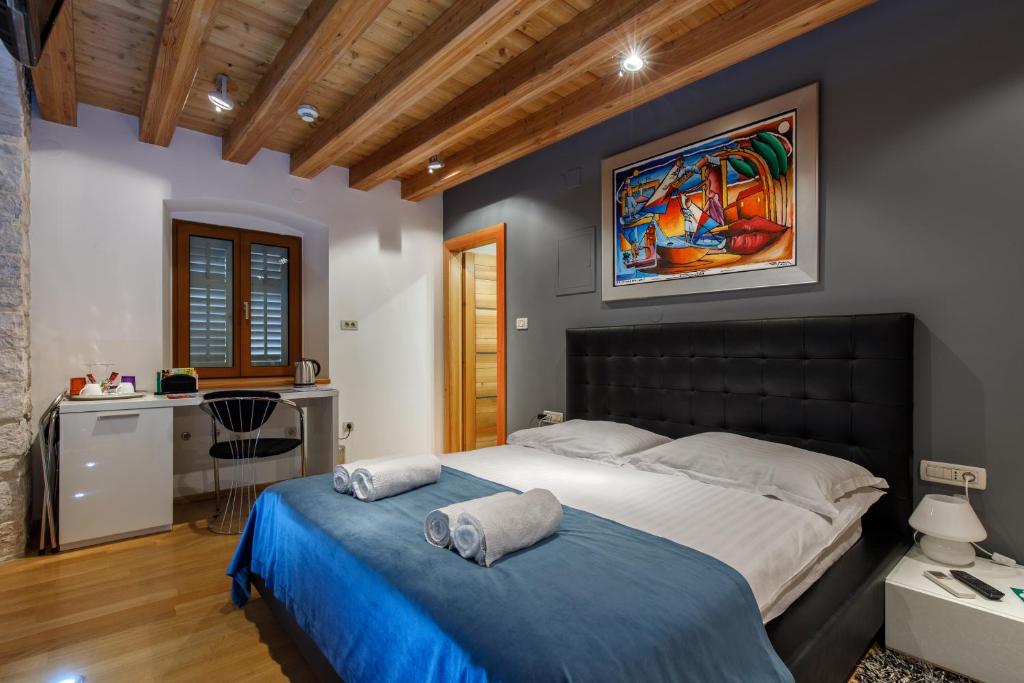 a bedroom with a large bed and a desk at Villa Marta in Split