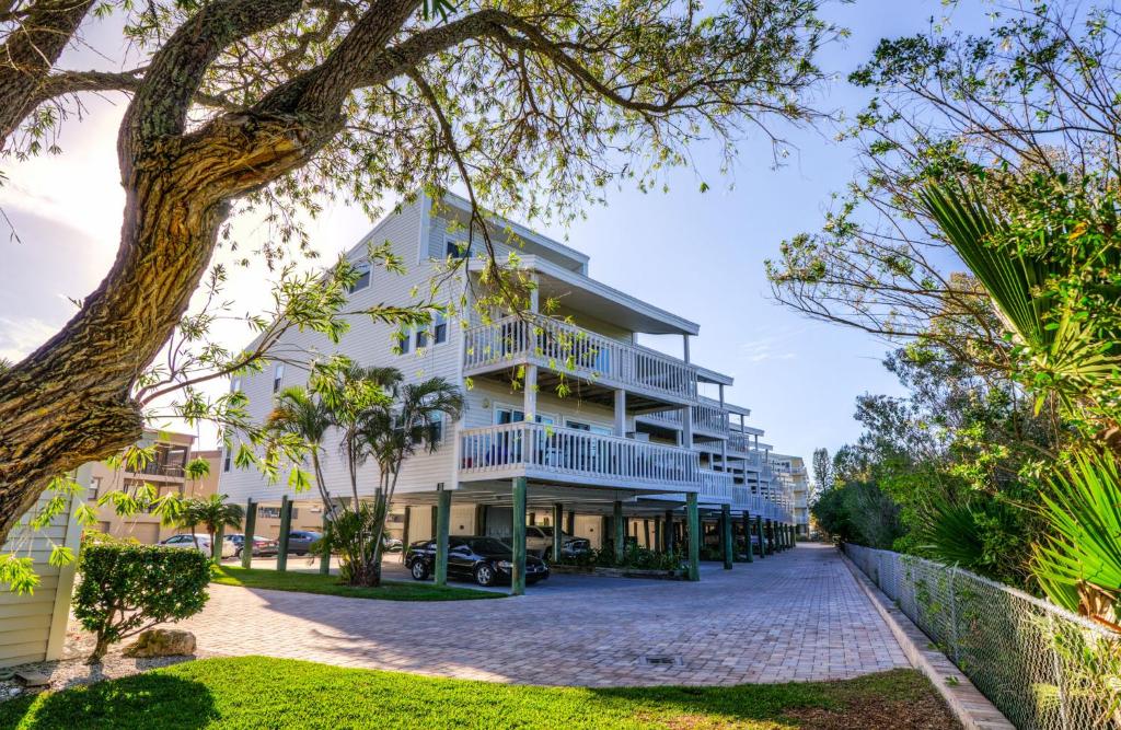 a large white building with balconies on a street at Intercoastal Beach Suite in Clearwater