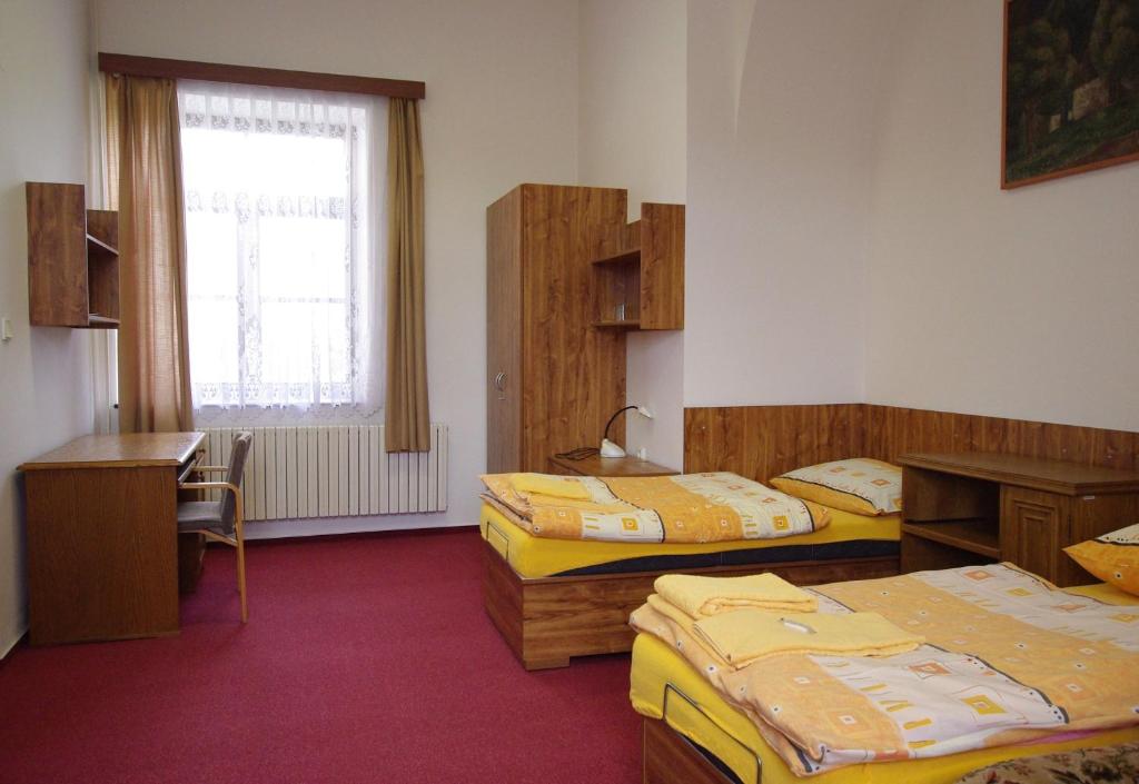 Postel nebo postele na pokoji v ubytování Koleje Zamecek