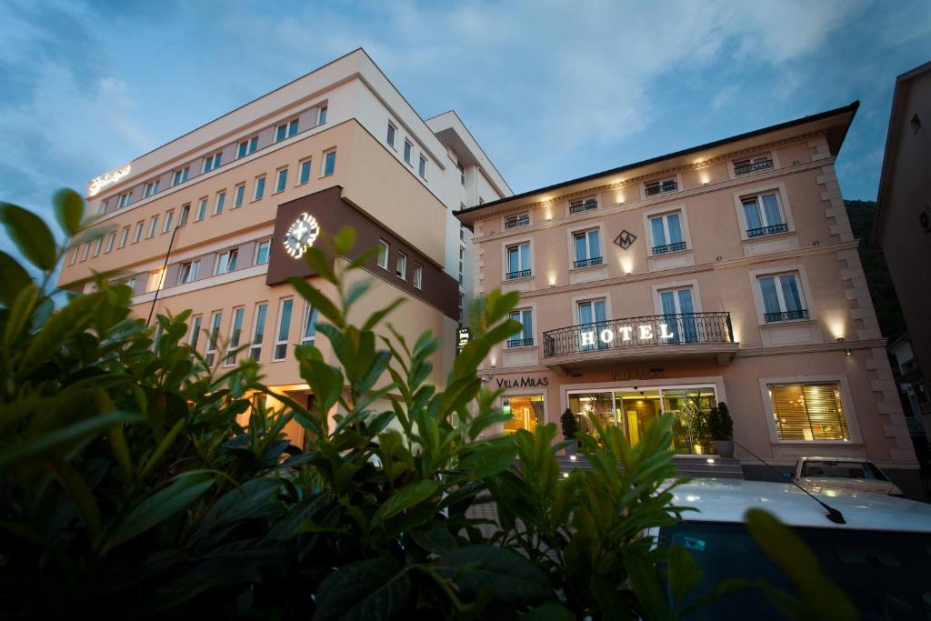 a building with a clock on the side of it at Hotel Villa Milas in Mostar