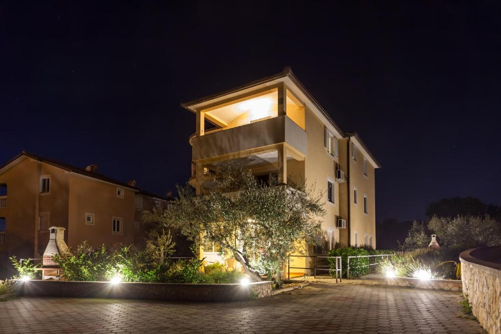 a large building with lights in front of it at night at Apartment Ivana 2435 in Malinska