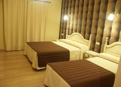 Postel nebo postele na pokoji v ubytování HOSTAL-CAFE GUTGRECO