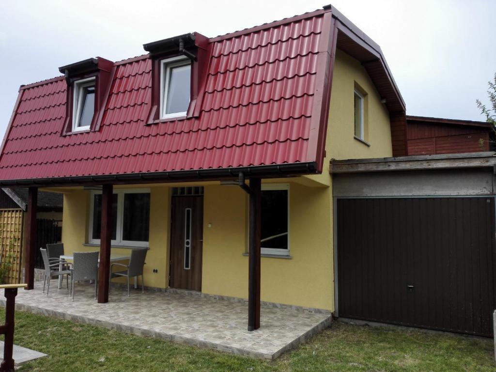 a house with a red roof and a garage at Dom Borys in Wisełka