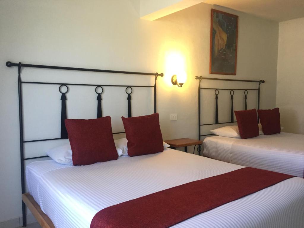 Postel nebo postele na pokoji v ubytování Hotel RV Park San Ramón