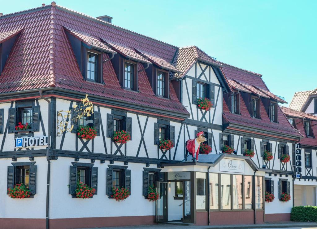 a building with a bird on the side of it at Hotel Ochsen in Friesenheim