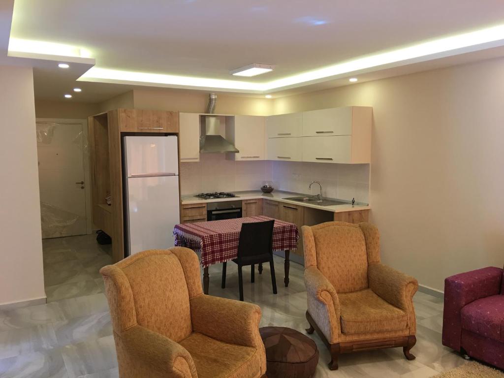 a kitchen with a table and chairs and a refrigerator at Royal Residence Nicosia in North Nicosia