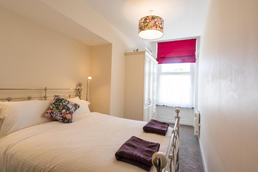 a bedroom with a bed with two towels on it at Kingsway Apartment in Bishop Auckland