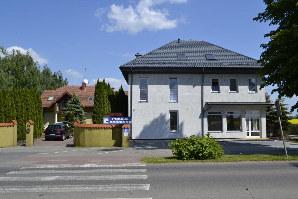a white building on the side of a street at U Marzeny I in Malbork