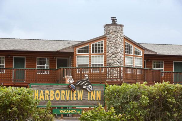 a large wooden house with a sign in front of it at Harborview Inn in Seward