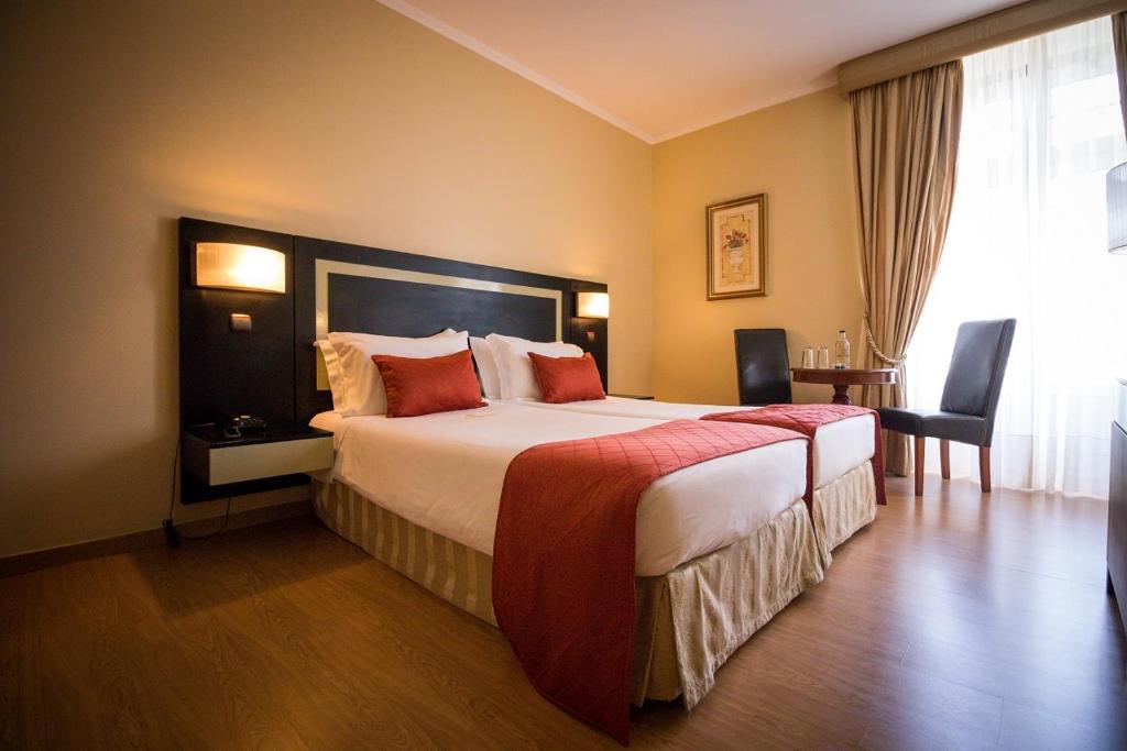 Postel nebo postele na pokoji v ubytování Hotel Talisman