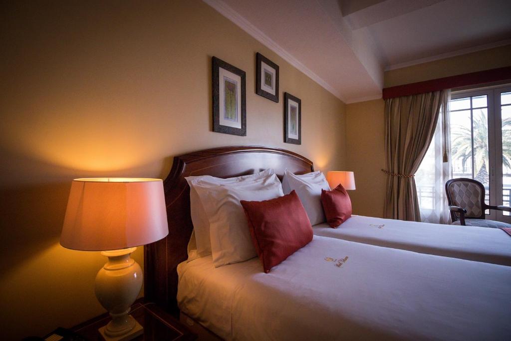 Postel nebo postele na pokoji v ubytování Hotel Talisman