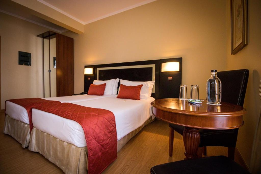 Postel nebo postele na pokoji v ubytování Hotel Talisman