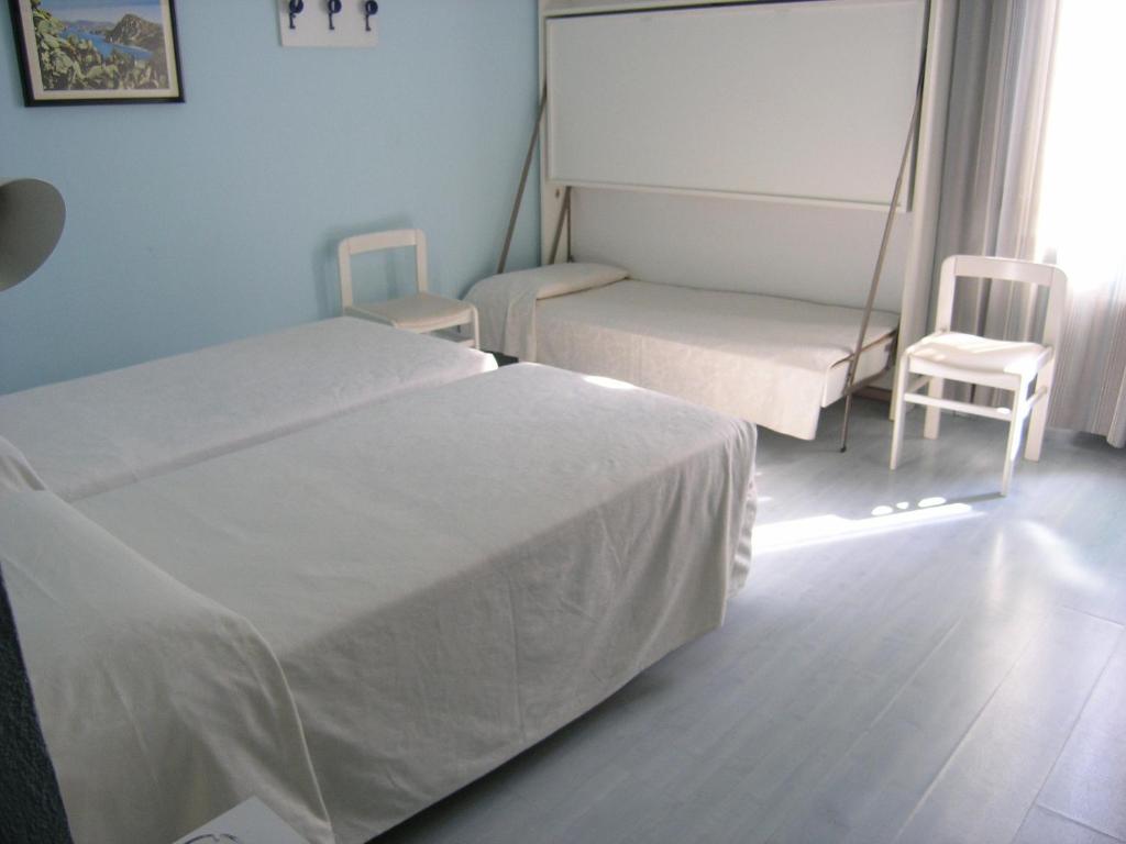 Postel nebo postele na pokoji v ubytování Elba Hotel