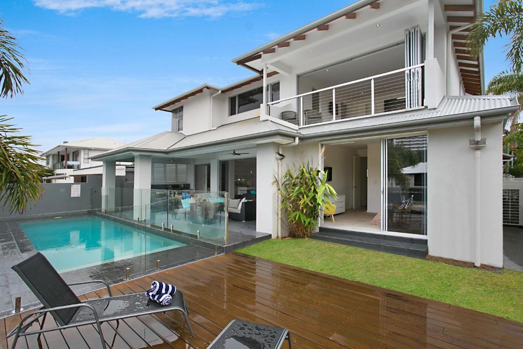 a house with a swimming pool in front of it at The Lotus in Gold Coast