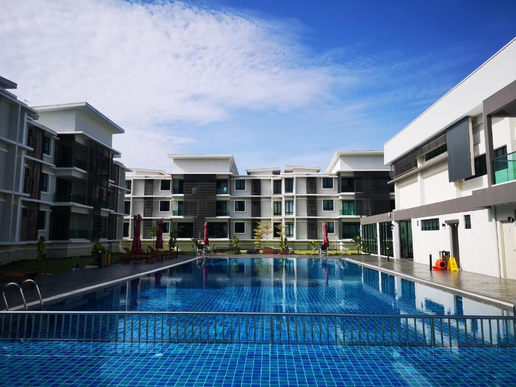 a swimming pool in front of a building at The Meadow Park in Kampar