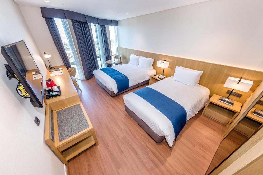 Postel nebo postele na pokoji v ubytování Hotel Sirius