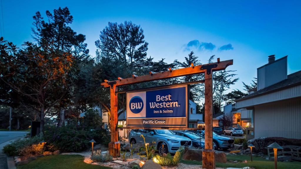 a sign for a best western sign in a parking lot at Best Western The Inn & Suites Pacific Grove in Pacific Grove