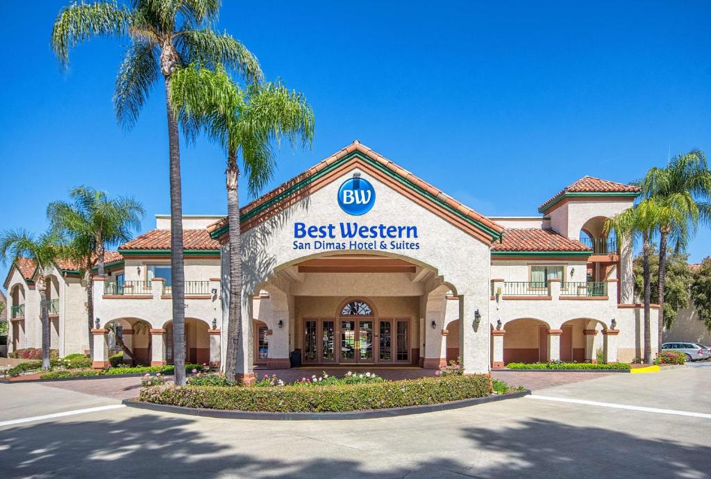 a best western building with palm trees in front of it at Best Western San Dimas Hotel & Suites in San Dimas