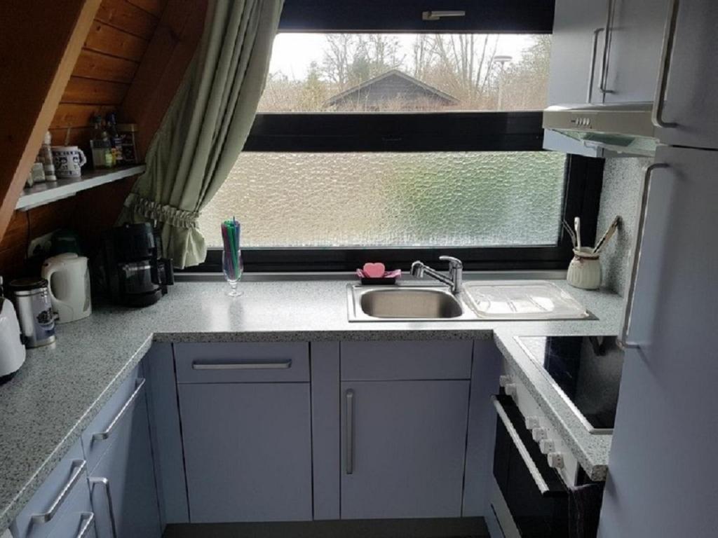 a small kitchen with a sink and a window at Ferienhaus Familie Mischkies in Damp