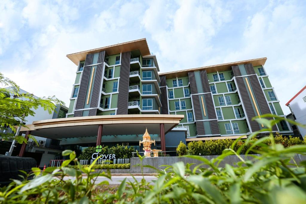 a large building with blue windows at Clover Hotel Hatyai in Hat Yai