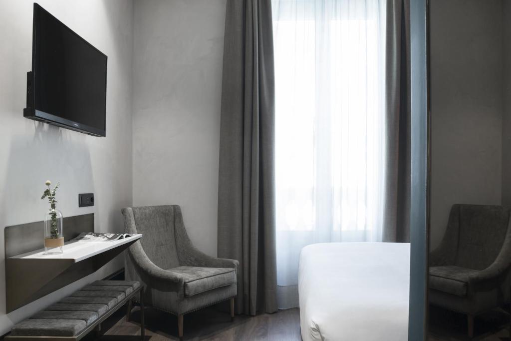 Televízia a/alebo spoločenská miestnosť v ubytovaní ICON Wipton