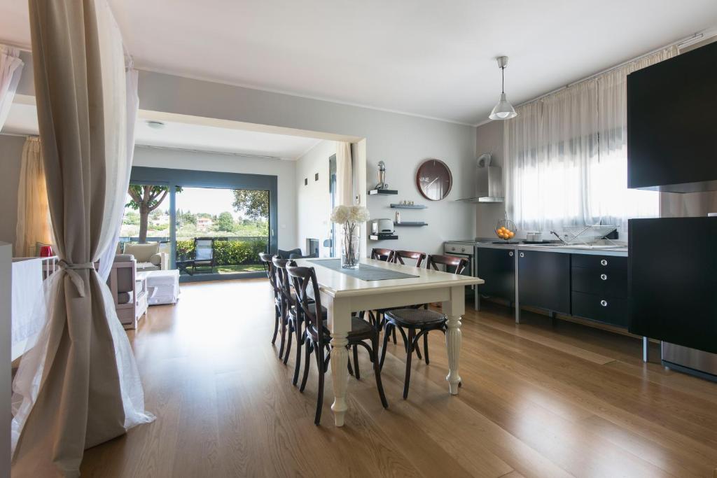 a kitchen and dining room with a table and chairs at #Luxlikehome - Tessi's House in Nea Kalikratia