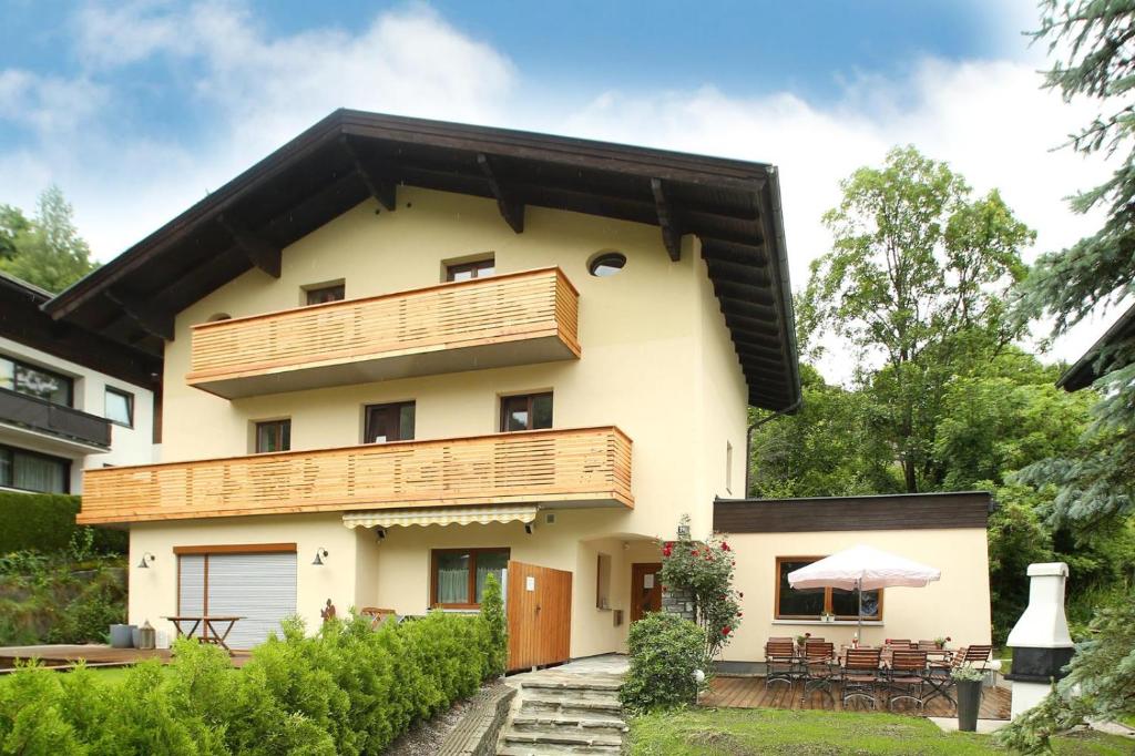 a house with wooden balconies and a patio at Chalet Jasmin in Zell am See