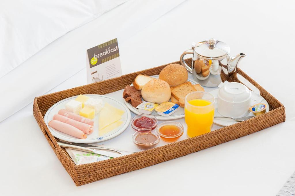 a tray of breakfast foods and drinks on a table at Athinais Hotel in Athens