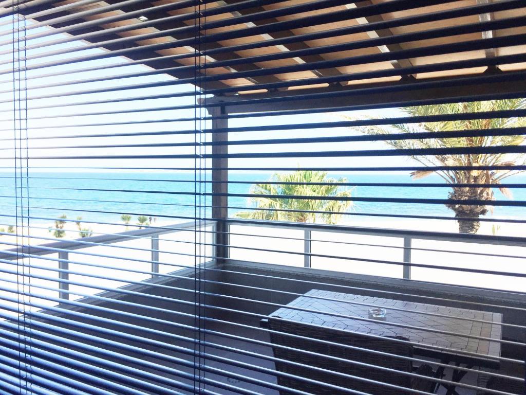 a room with a large window with blinds at Location! 15m to Beach Mojacar in Mojácar