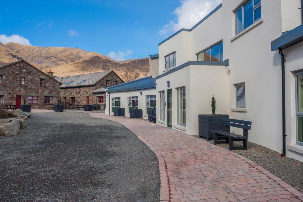 a cobblestone street in a town with buildings at Wild Atlantic Hostel in Leenaun