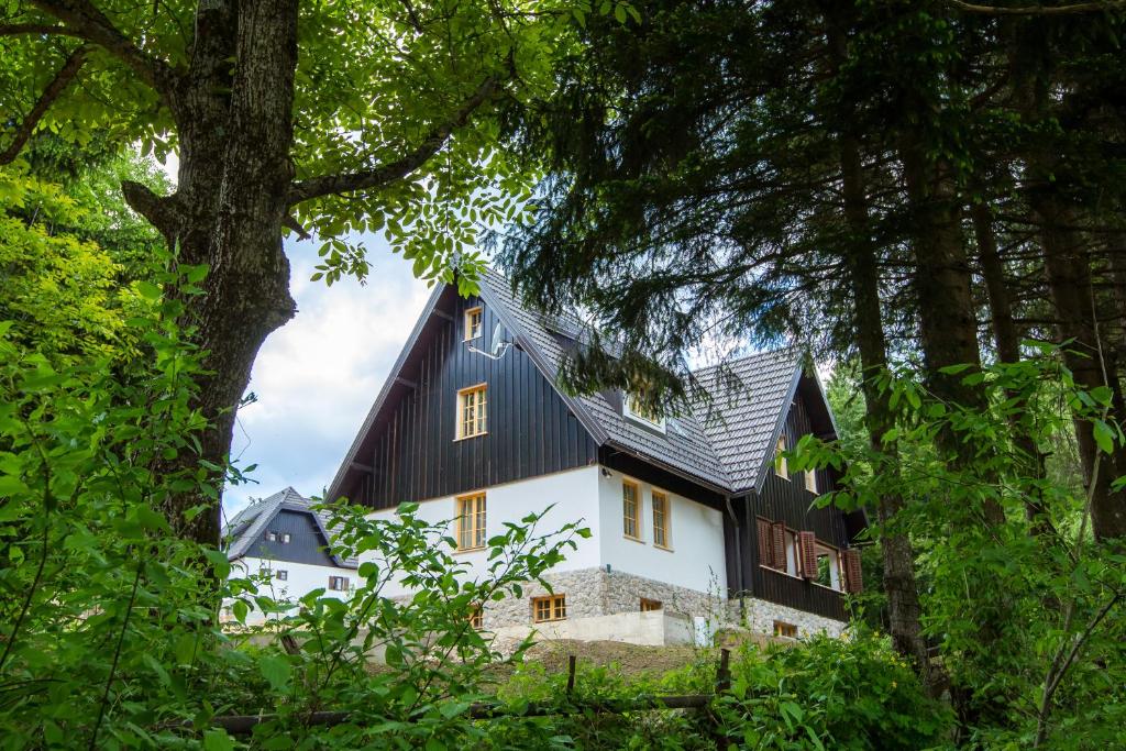 a large white house with a black roof at B&B Plitvica Creek in Plitvica Selo