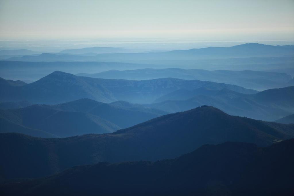 a view of a mountain range with the sky at La Maison Verte in Les Plantiers