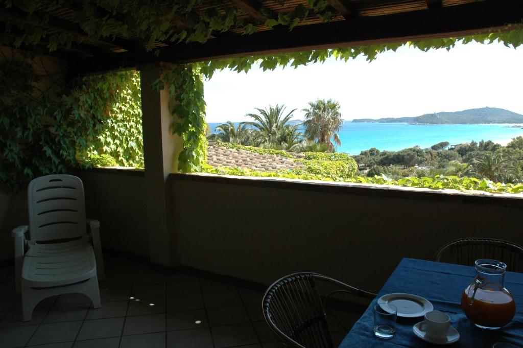 a room with a table and a view of the ocean at Residence Fenicia in Villasimius