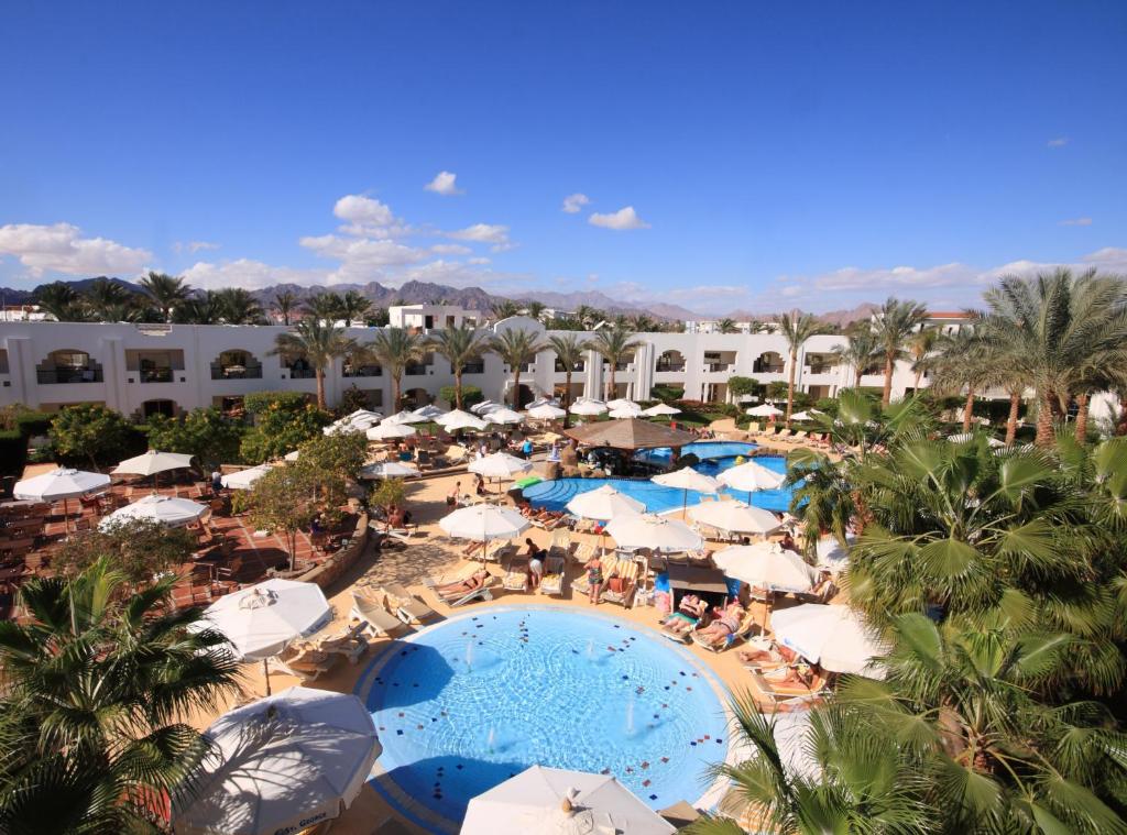 an aerial view of a resort with a pool and umbrellas at Xperience St. George Sharm El Sheikh in Sharm El Sheikh