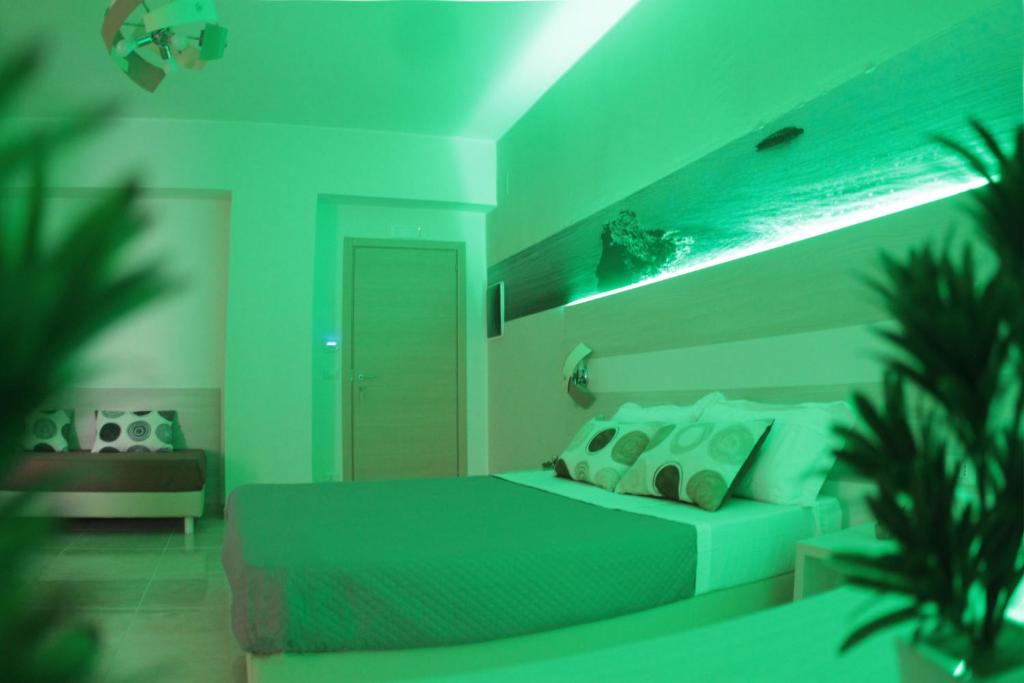 Postel nebo postele na pokoji v ubytování A'MANTIA HOTEL