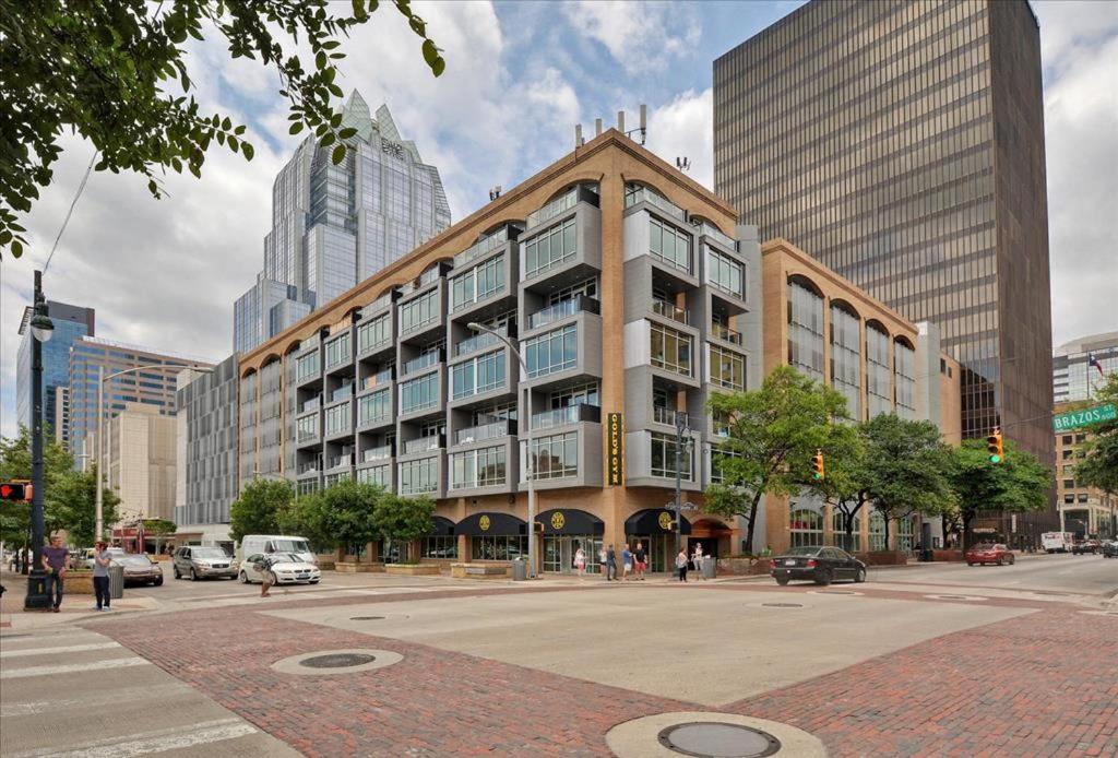 a large building on a city street with tall buildings at Littlefield Lofts #502 in Austin
