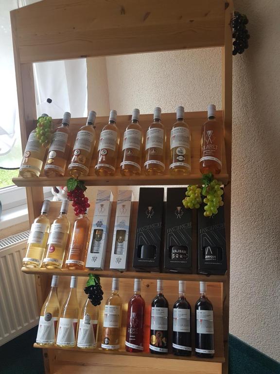 a shelf with many bottles of alcohol on it at Pension Sunset Mezirolí in Nová Role