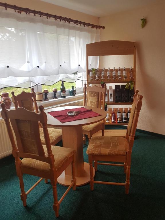 a kitchen with a table and two chairs and a window at Pension Sunset Mezirolí in Nová Role