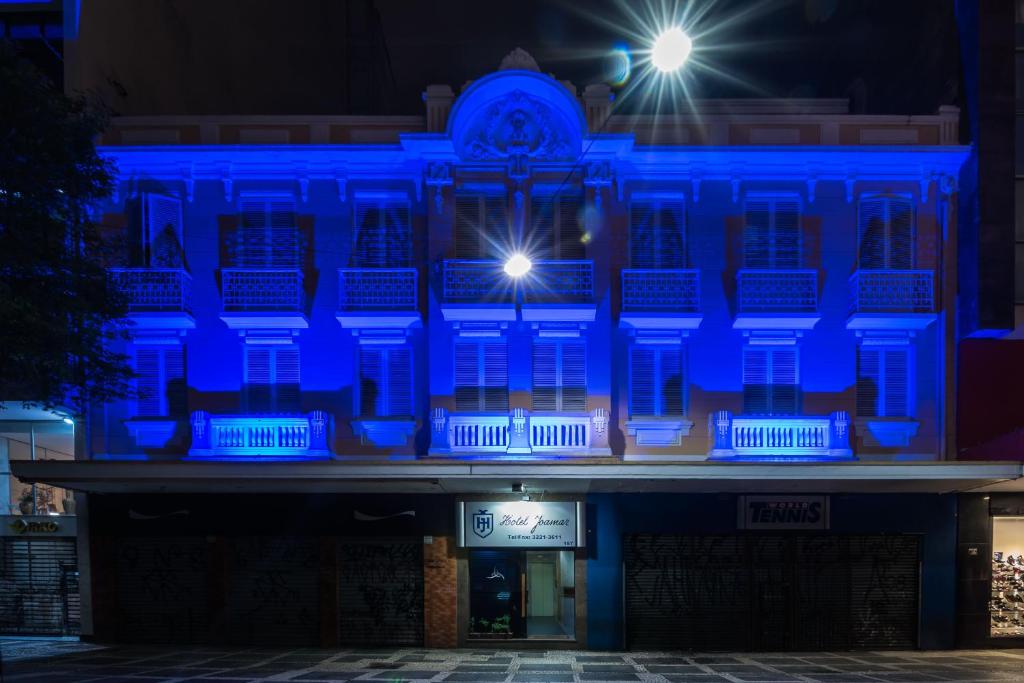 un edificio con luces azules por la noche en Hotel Joamar, en São Paulo