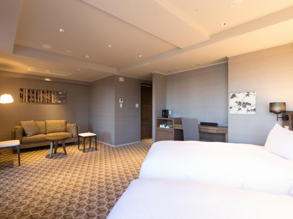 Postel nebo postele na pokoji v ubytování Hotel Shiki Utsubo Park