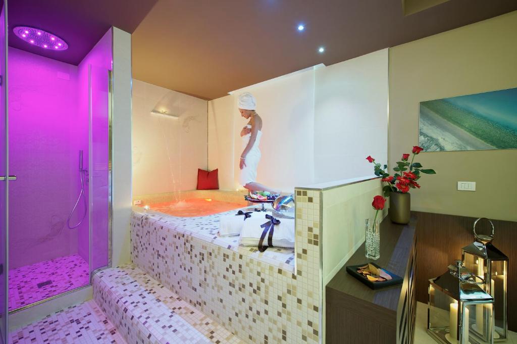 A bed or beds in a room at UNAHOTELS Villa dei Platani Foligno