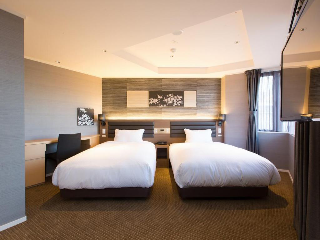 Postel nebo postele na pokoji v ubytování Hotel Shiki Utsubo Park