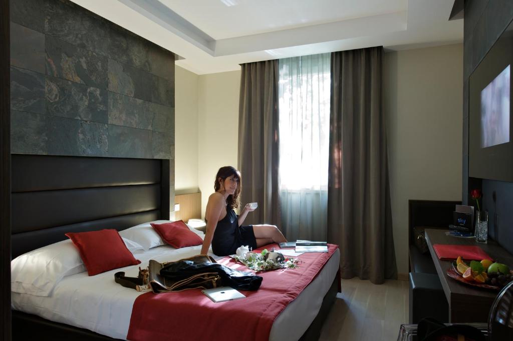 A bed or beds in a room at UNAHOTELS Villa dei Platani Foligno