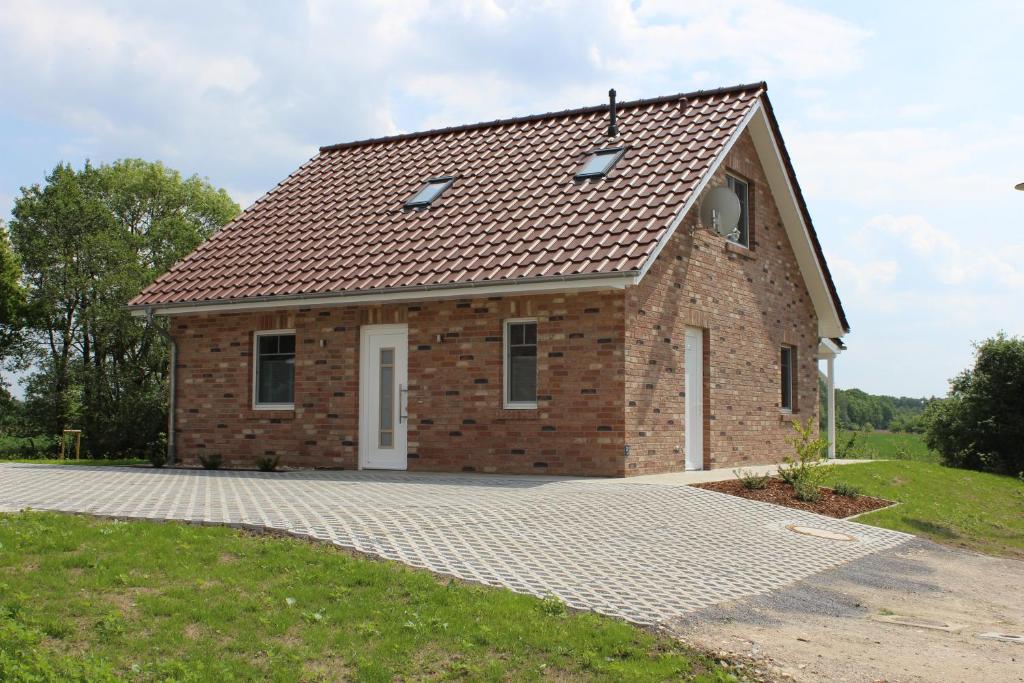 una casa de ladrillo con techo de baldosa en Haus Kornblume en Oberlangen