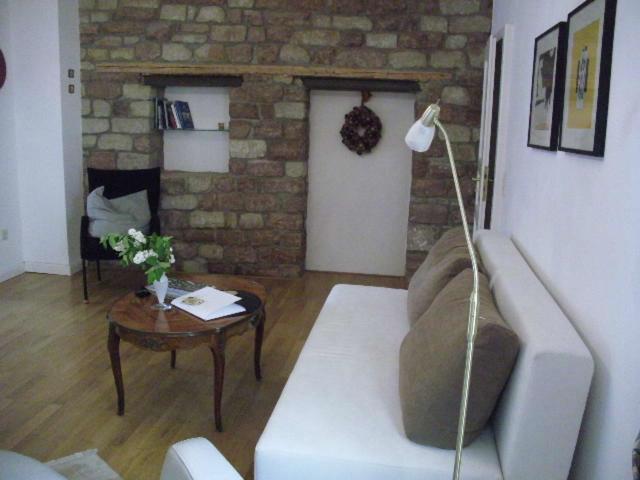 a living room with a white couch and a table at Gästehaus Stadtmitte in Merzig