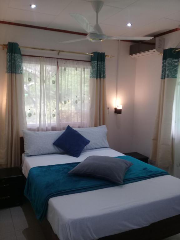 拉迪格島的住宿－Agnes Cottage，一间卧室设有两张床和窗户。